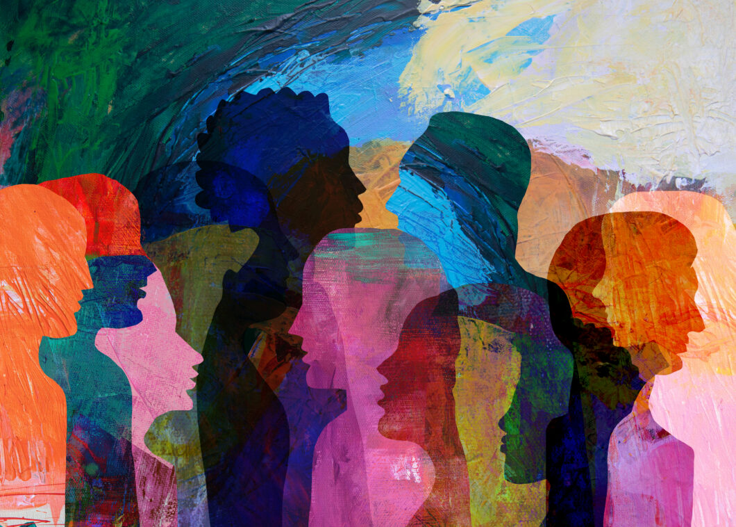 Abstract artwork featuring overlapping silhouettes of people in profile against a textured, multicolored painted background. The layered figures appear in shades of blue, green, pink, orange, and purple, creating a diverse collage-like composition with expressive brushstrokes and translucent forms.