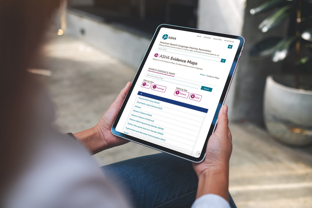 Person holding a tablet displaying the ASHA Evidence Maps website and searchable evidence resources.