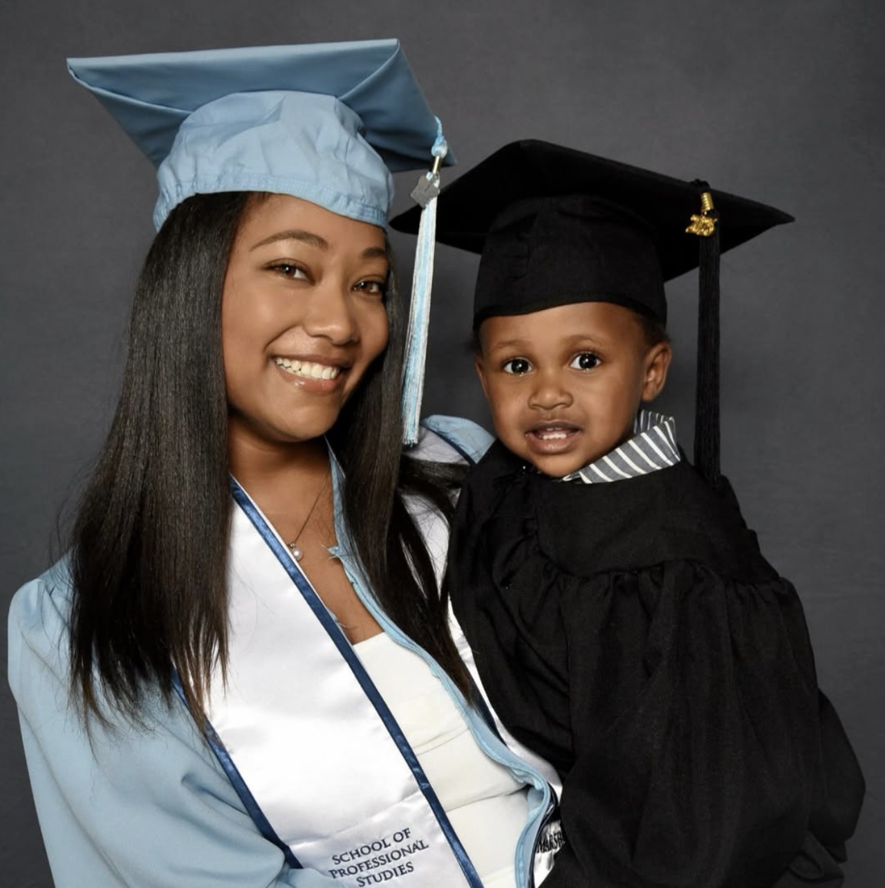 Narrative Medicine '25 Graduate Miniya Williams poses with her son in a cap and gown. 