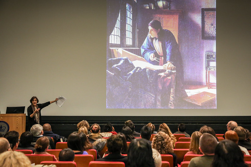 Rita Charon stands at a lectern in front of an audience of students.