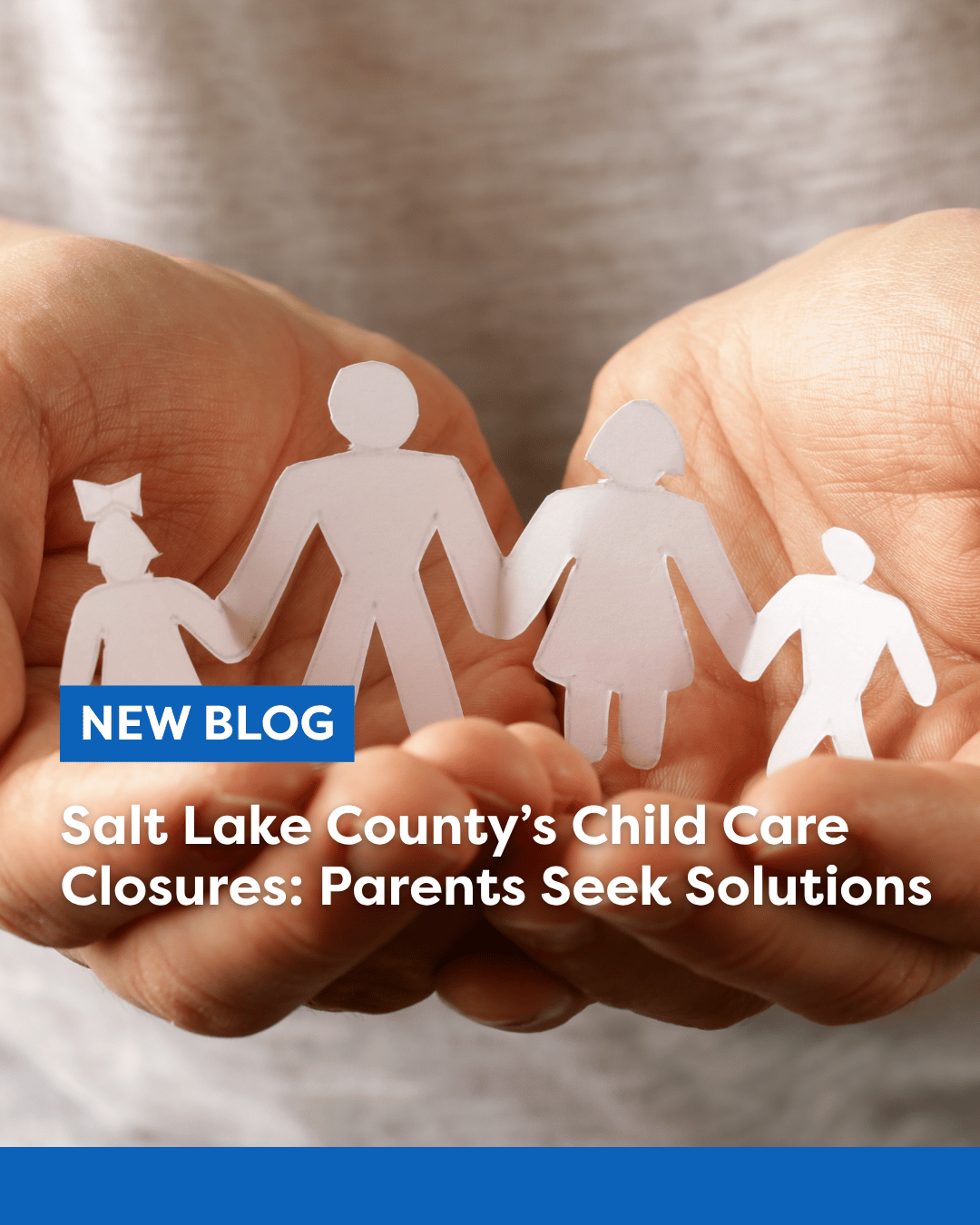 Hand holding a paper cut out of a family