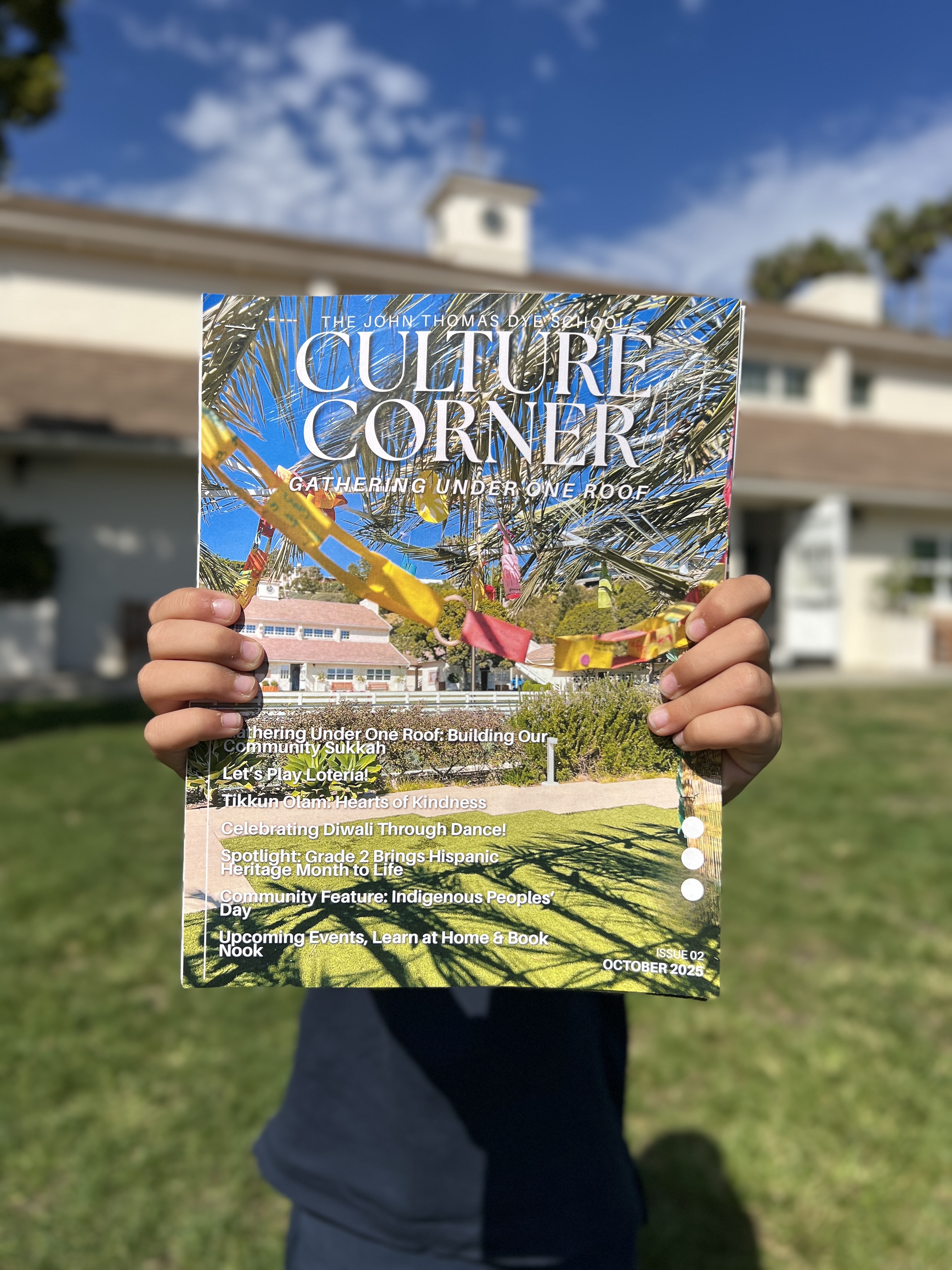 Student Holding the October 2025 issue of the Culture Corner